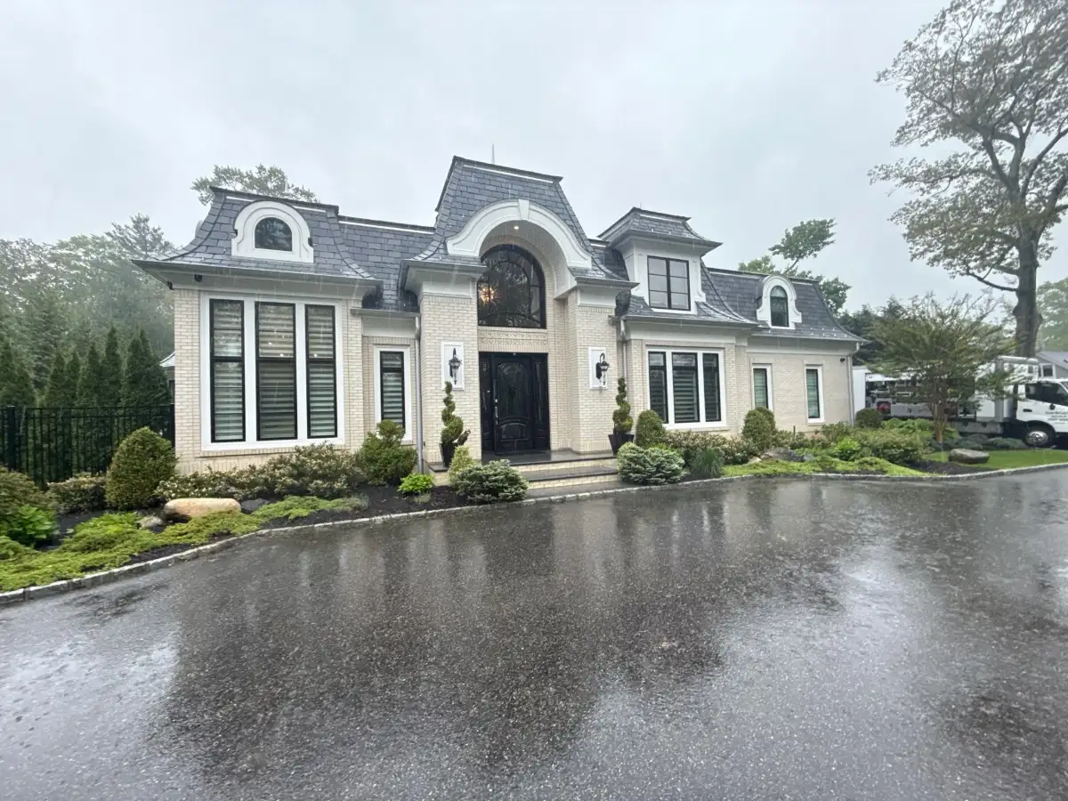 Matthew rinsing home in Old Westbury NY — house washing by Pressure Wash Long Island