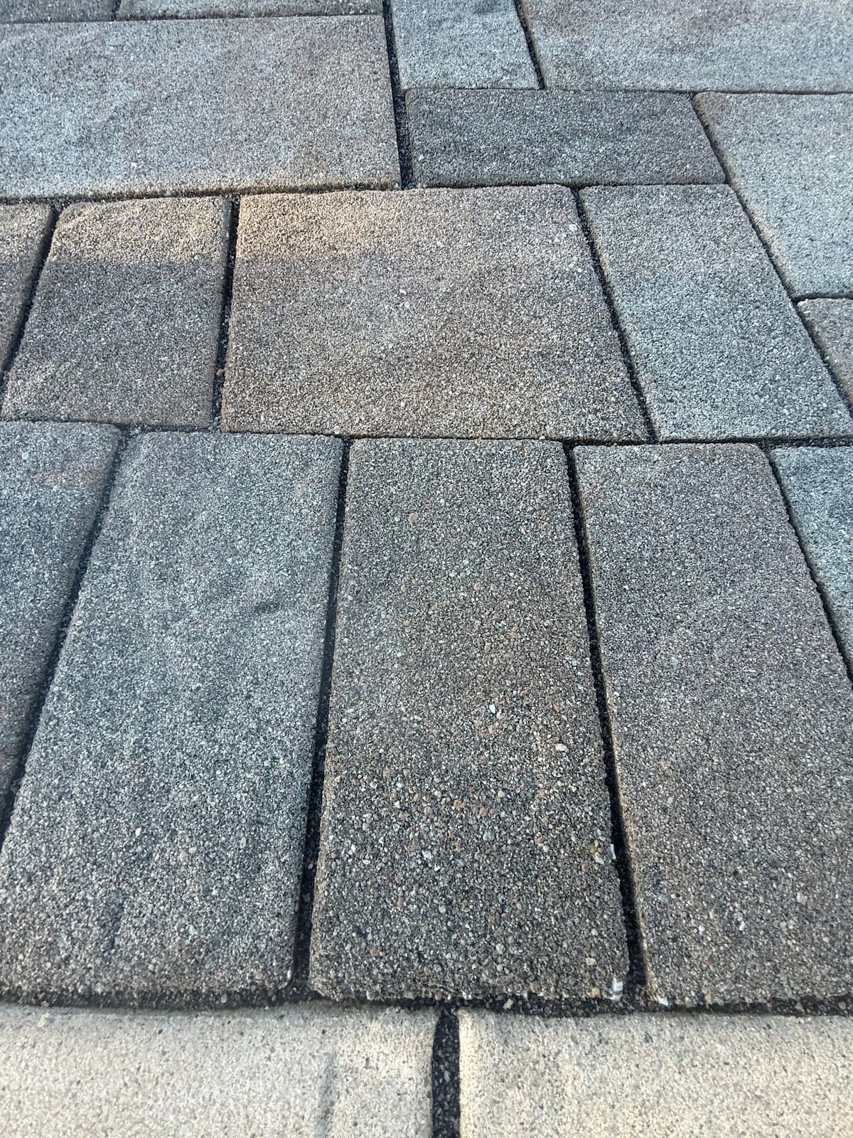 Correct joint sand depth on a round-edge paver — sand installed to the base of the radius, not flush with the surface — Pressure Wash Long Island, Nassau County