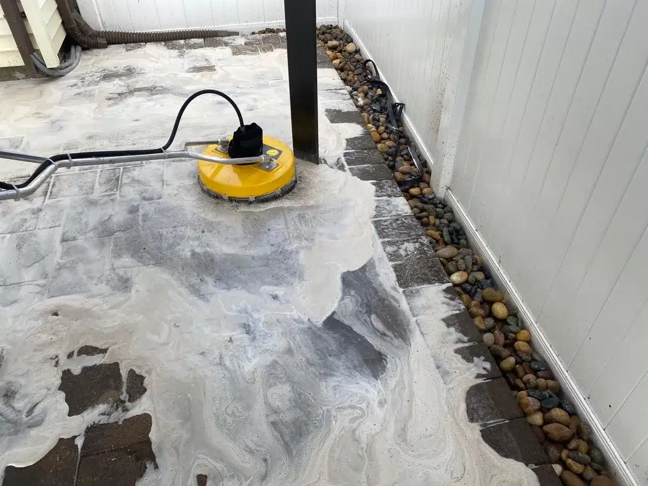 Commercial surface cleaner removing buildup from natural stone pavers during paver restoration — Pressure Wash Long Island