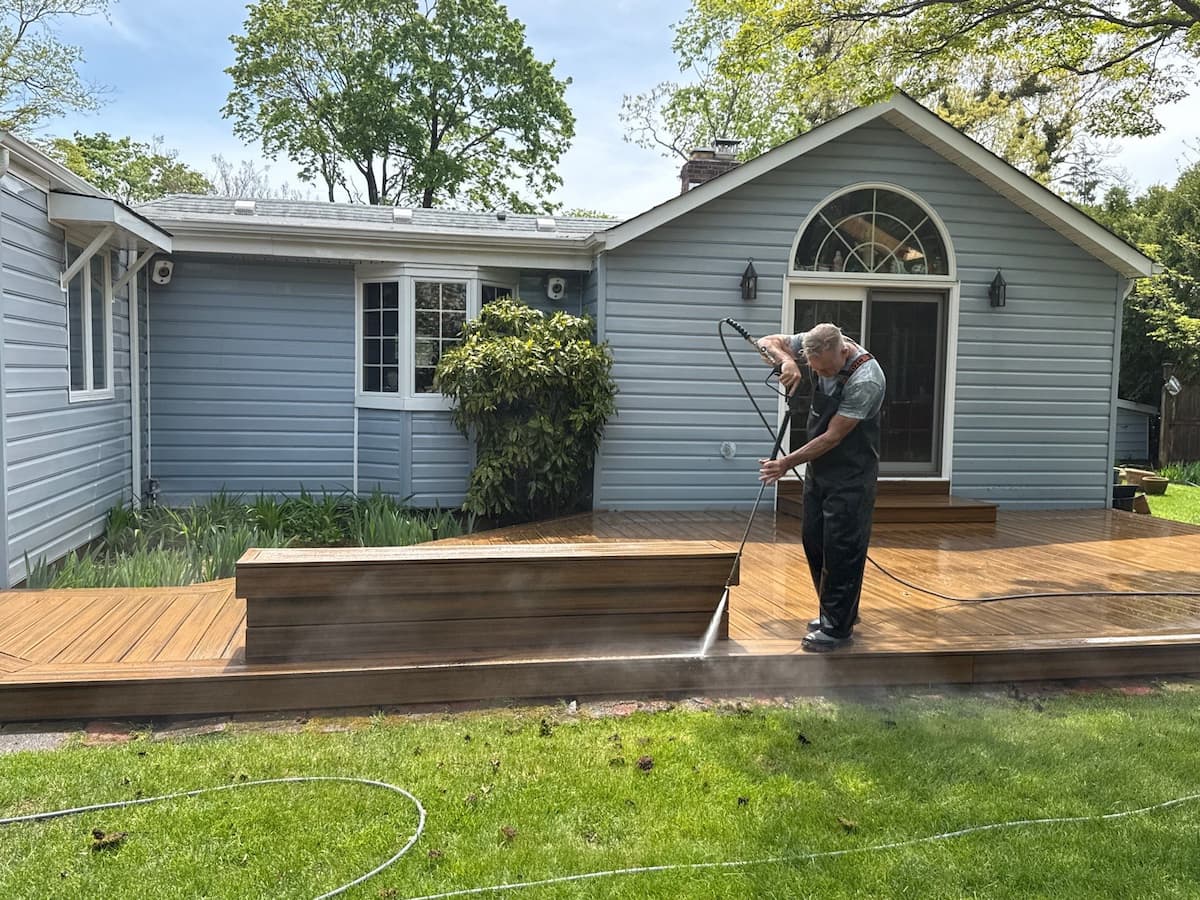 Kevin pressure washing a composite deck at a Syosset NY home — deck cleaning by Pressure Wash Long Island