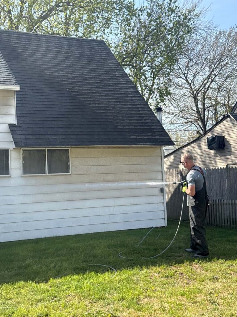 Kevin pressure washing vinyl siding at a Levittown NY home — house washing by Pressure Wash Long Island